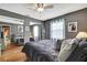 Serene bedroom featuring a mirrored closet, gray walls and hardwood flooring at 10924 Archway Ave, Hudson, FL 34667