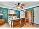 Comfortable bedroom with green walls, wood furniture, and a decorative ceiling fan at 10924 Archway Ave, Hudson, FL 34667