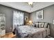 Relaxing bedroom with gray walls, hardwood floors, and a bright window at 10924 Archway Ave, Hudson, FL 34667