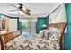 Bright bedroom showcasing floral bedding, a ceiling fan, and view of the pool at 10924 Archway Ave, Hudson, FL 34667