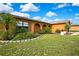 A lovely single-story home boasting mature landscaping and a well-maintained lawn at 10924 Archway Ave, Hudson, FL 34667