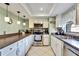 Updated kitchen with stainless steel appliances, recessed lighting, and ample counter space at 10924 Archway Ave, Hudson, FL 34667