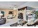 Bright and airy living room area with tile flooring, comfortable seating, and a view into the kitchen at 10924 Archway Ave, Hudson, FL 34667