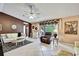 Open living room featuring tile flooring, comfortable seating, and access to the outdoor pool area at 10924 Archway Ave, Hudson, FL 34667