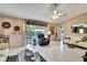 A view of the living room area, featuring a wet bar and access to the outdoor pool area at 10924 Archway Ave, Hudson, FL 34667