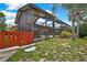 Exterior of screened pool enclosure and backyard featuring lush landscaping and partial fence at 10924 Archway Ave, Hudson, FL 34667