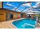 Enclosed pool area featuring a sparkling in-ground pool, lounge chairs, and ample space for outdoor enjoyment at 10924 Archway Ave, Hudson, FL 34667