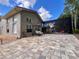 Exterior view showcasing a paver patio, porch swing, enclosed pool area, and lush backyard, perfect for outdoor enjoyment at 10060 Chip Ln, New Port Richey, FL 34654