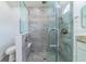 A modern tiled glass shower and toilet are adjacent to the vanity in the bathroom at 10060 Chip Ln, New Port Richey, FL 34654