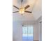 This bedroom has carpet, ceiling fan, and a slider to the backyard at 10060 Chip Ln, New Port Richey, FL 34654