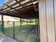 Carport with brown metal structure over a fenced yard at 10060 Chip Ln, New Port Richey, FL 34654