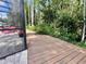 Wooden deck is a great backyard feature next to a screened pool and lush yard for relaxation and entertainment at 10060 Chip Ln, New Port Richey, FL 34654