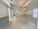 Open dining room featuring tile floors, neutral paint, and a modern chandelier at 10060 Chip Ln, New Port Richey, FL 34654
