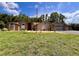 Well-maintained single-story house with a manicured lawn, stone accents, and a three-car garage at 10060 Chip Ln, New Port Richey, FL 34654