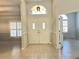 Bright foyer with a double front door, tile flooring, and large windows providing ample natural light at 10060 Chip Ln, New Port Richey, FL 34654