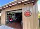 A 'Personal Cave' sign hangs next to a partially open garage door, revealing a cluttered but functional space at 10060 Chip Ln, New Port Richey, FL 34654