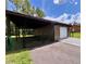 Metal garage with a lean to for parking and storage on a large residential lot at 10060 Chip Ln, New Port Richey, FL 34654
