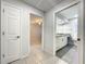 A hallway connects a bedroom to a bathroom, showcasing the home's layout and design at 10060 Chip Ln, New Port Richey, FL 34654