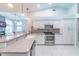 A bright kitchen features stainless steel appliances and opens to the breakfast nook and living room at 10060 Chip Ln, New Port Richey, FL 34654