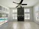 Bright living room features tile floors, fireplace, shutters, and sliding glass doors leading to the pool at 10060 Chip Ln, New Port Richey, FL 34654