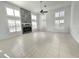 Bright living room features tile floors, fireplace, shutters, and a ceiling fan at 10060 Chip Ln, New Port Richey, FL 34654
