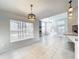 Open-concept living space featuring tile flooring, multiple windows, and views of the screened patio at 10060 Chip Ln, New Port Richey, FL 34654