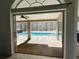 Looking out onto a screened-in pool surrounded by brick pavers and a refreshing water feature at 10060 Chip Ln, New Port Richey, FL 34654