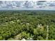 Expansive aerial shot of a property surrounded by dense, green trees and natural landscapes at 10097 Weatherly Rd, Brooksville, FL 34601