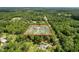Aerial view highlighting property lines of a home nestled within a lush, green treed landscape at 10097 Weatherly Rd, Brooksville, FL 34601
