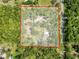 An aerial view of the property showing the house, the land plot and the privacy provided by the surrounding trees at 10097 Weatherly Rd, Brooksville, FL 34601