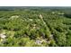 Aerial view of a property surrounded by lush trees, offering privacy and a serene setting at 10097 Weatherly Rd, Brooksville, FL 34601