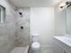 Bright bathroom showcasing a tiled walk-in shower, modern fixtures, and white vanity for a clean and updated look at 10097 Weatherly Rd, Brooksville, FL 34601