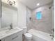 Bright bathroom showcasing a tiled tub/shower combination, updated vanity, and modern fixtures at 10097 Weatherly Rd, Brooksville, FL 34601
