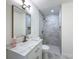 Updated bathroom featuring a marble countertop, modern fixtures, and a stylish tiled shower with a built-in niche at 10097 Weatherly Rd, Brooksville, FL 34601