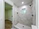 Modern bathroom featuring a tile shower and mosaic floor at 10097 Weatherly Rd, Brooksville, FL 34601