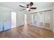 Bright bedroom with hardwood floors, ceiling fan and a sliding door mirrored closet at 10097 Weatherly Rd, Brooksville, FL 34601