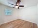 Inviting bedroom featuring wood floors, a ceiling fan, and a bright window creating a cozy atmosphere at 10097 Weatherly Rd, Brooksville, FL 34601