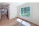 Dining area with large window overlooking wooded area and bright natural light at 10097 Weatherly Rd, Brooksville, FL 34601
