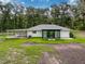 Rear view shows patio and enclosed porch at 10097 Weatherly Rd, Brooksville, FL 34601