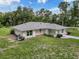Well-maintained single-story home featuring a bright exterior, complemented by verdant lawn and landscaping at 10097 Weatherly Rd, Brooksville, FL 34601