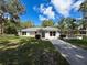 Charming single-story home with well-manicured lawn, bright white exterior, and a welcoming entrance at 10097 Weatherly Rd, Brooksville, FL 34601