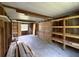 Bright, open interior of garage showcasing shelving and natural light from window at 10097 Weatherly Rd, Brooksville, FL 34601