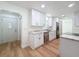 This kitchen is renovated with white cabinetry, granite countertops, stainless appliances and hardwood floors at 10097 Weatherly Rd, Brooksville, FL 34601