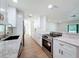 An open and airy kitchen featuring stainless steel appliances, light countertops and a stylish breakfast bar at 10097 Weatherly Rd, Brooksville, FL 34601