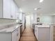 This streamlined kitchen features granite countertops, new appliances, white cabinets and an open design at 10097 Weatherly Rd, Brooksville, FL 34601