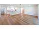 Open-concept living room and kitchen with wood flooring and white trim at 10097 Weatherly Rd, Brooksville, FL 34601