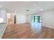 Open floor plan with wood floors and access to the screened lanai at 10097 Weatherly Rd, Brooksville, FL 34601