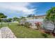 Lovely fenced backyard with a stone pathway, green lawn, and decorative landscaping at 10600 Oleander Dr, Port Richey, FL 34668
