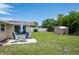 Inviting backyard with patio seating, lush greenery, and a convenient storage shed at 10600 Oleander Dr, Port Richey, FL 34668