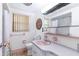 Vintage bathroom with pink fixtures, including a sink and retro details for a unique look at 10600 Oleander Dr, Port Richey, FL 34668